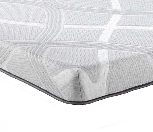 Tuck 3lb Gel Visco Memory Foam close up of the corner of the bed. Corner seam runs vertically as the top fabric wraps around the side. Large dark grey welt on the bottom of the mattress. 